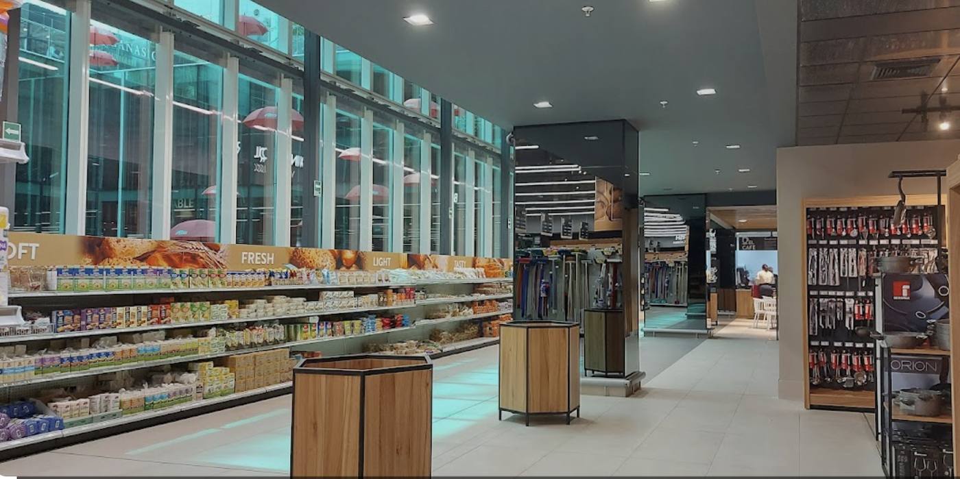 A grocery store aisle with produce and local prices visible.