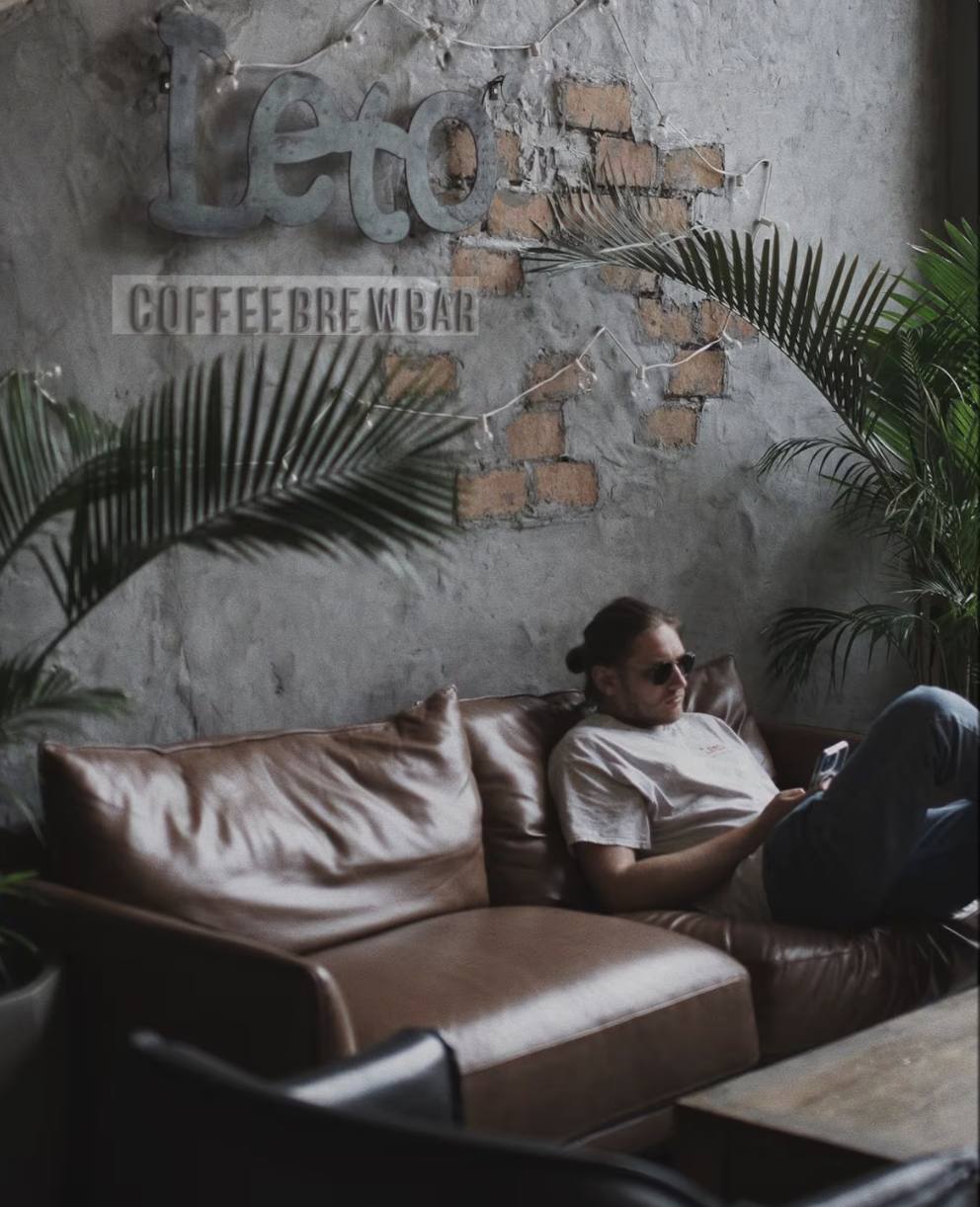 Two people in conversation across a quiet table in a Panama City office.